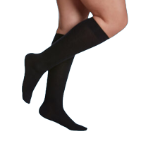 Black compression socks worn on a model's legs, emphasizing support for foot health and mobility, relevant to custom orthotic solutions offered by Brace Lady.